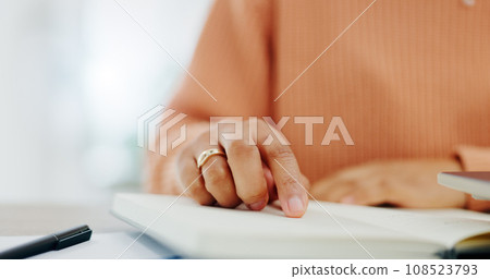 Notes, woman and hand with book for planning, schedule and home office with paperwork. Diary, planner and journal writing with a person at a desk with notebook and documents for writing in a house 108523793