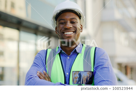 Black man, portrait and construction worker arms crossed, architect or contractor smile with pride. Architecture, infrastructure with urban development and professional engineer outdoor at job site 108523944