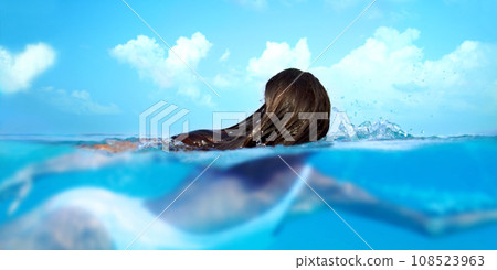 Woman, nature and ocean swimming for travel, holiday and sea water on a tropical island. Hawaii, outdoor and female person relax on a summer vacation with peace and adventure by beach in paradise 108523963