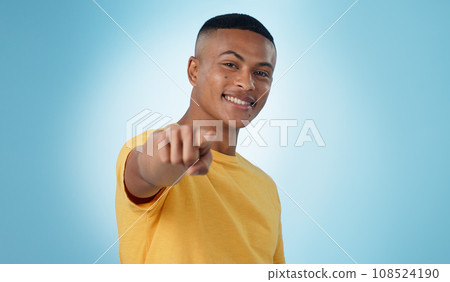 Man, portrait and pointing to you in studio for choice, vote for winner and decision to volunteer on blue background. Happy model show finger for recruitment, hiring emoji and invitation to join us 108524190