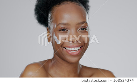 Black woman, face and cream with beauty, skincare and healthy skin for portrait, moisturizer and blue studio background. Happy, female and sunscreen for dermatology, cosmetology and luxury product 108524374