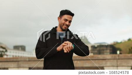 Smart watch, happy and man in city for exercise, cardio fitness and healthy training progress. Indian runner check stopwatch for timer, heart rate and workout performance, clock and results outdoor 108524578
