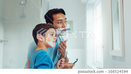 Shaving cream, child and father teaching in bathroom, family home or boy learning morning skincare, beauty and grooming routine. Shave together, son and dad helping with foam, razor and skin care Shaving cream, child and father teaching in bathroom, family home or boy learning morning skincare, beauty and grooming routine. Shave together, son and dad helping with foam, razor and skin care 108524594
