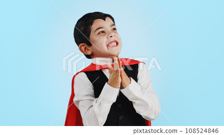Choice, halloween and excited child in costume ready for event, hungry and isolated in a studio blue background. Option, checklist and funny young kid with comedy, joy and happiness for holiday 108524846