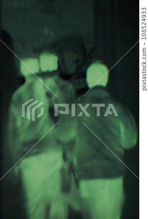 Military, people and green night vision, walking or dark silhouette of spy, agent or terrorist with soldier. Police, surveillance or men training in infrared scope for army or security mission 108524933
