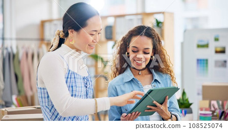 Woman, fashion designer and tablet in meeting, planning or logistics in small business together at office. Creative female person or employees working on technology for clothing design or startup 108525074
