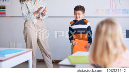 Class, presentation and child speaker with applause and cheering in classroom at school. Young kid, education and oral reading of project with a student and teacher with children group in discussion 108525342