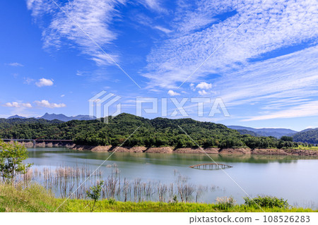 Yubaridake and Yubarimaedake towering behind the Shirogane Bridge ruins in Yubari City, Hokkaido [August] 108526283