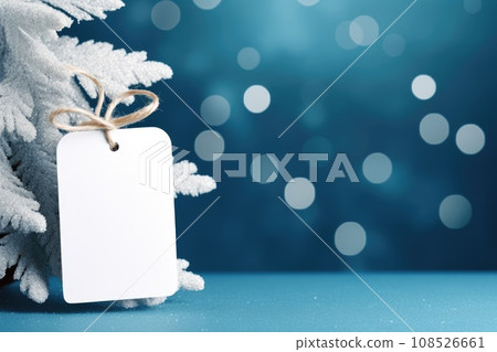 White blank price tag on blue background with Christmas tree branch. Copy space. White blank price tag on blue background with Christmas tree branch. Copy space. 108526661