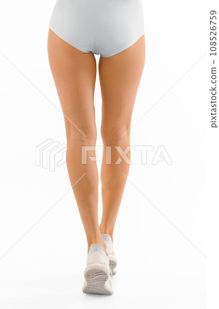 Back view of slender legs of sportive woman 108526759
