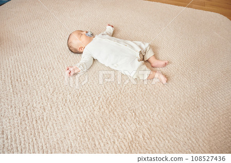 Baby sleeping with a pacifier 108527436