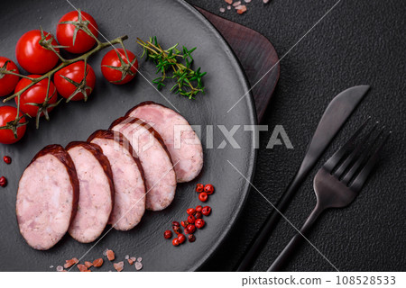 Delicious smoked sausage with salt and spices cut into slices 108528533
