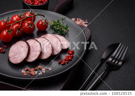 Delicious smoked sausage with salt and spices cut into slices 108528535