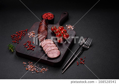 Delicious smoked sausage with salt and spices cut into slices 108528541