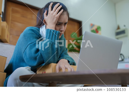 Starting small business entrepreneur of independent Asian woman showing her face worried about the sales of her business not reaching the target set. SME concepts. 108530133