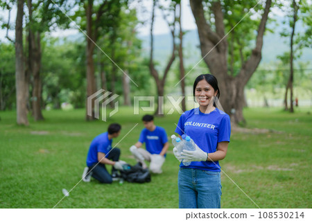 Multiethnic volunteers donate their time holding black garbage bags to collect plastic waste for recycling to reduce pollution in a public park Multiethnic volunteers donate their time holding black garbage bags to collect plastic waste for recycling to reduce pollution in a public park 108530214