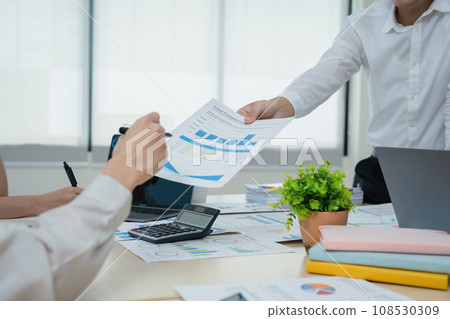 Asian business advisor meeting to analyze and discuss the situation on the financial report in the meeting room.Investment Consultant, Financial , teamwork ,brainstorming ,startup and accounting. 108530309