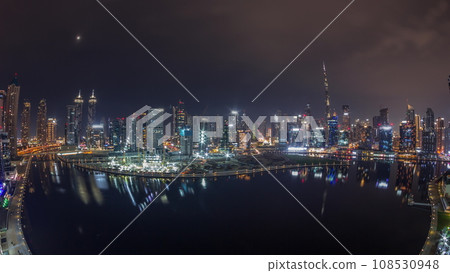 Aerial view to Dubai Business Bay and Downtown with the various skyscrapers and towers night timelapse Aerial view to Dubai Business Bay and Downtown with the various skyscrapers and towers night timelapse 108530948