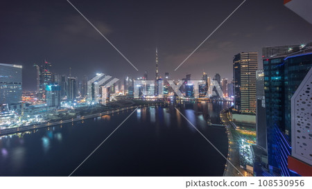 Aerial view to Dubai Business Bay and Downtown with the various skyscrapers and towers all night timelapse Aerial view to Dubai Business Bay and Downtown with the various skyscrapers and towers all night timelapse 108530956