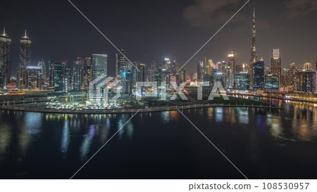 Panorama showing aerial view to Dubai Business Bay and Downtown with the various skyscrapers and towers night timelapse Panorama showing aerial view to Dubai Business Bay and Downtown with the various skyscrapers and towers night timelapse 108530957