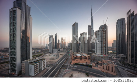 Aerial view of Dubai Downtown skyline with many towers night to day timelapse. 108531083