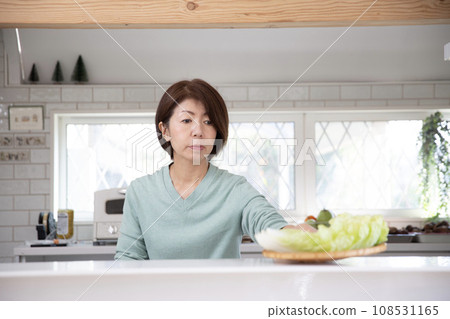 Japanese middle-aged woman cooking in the kitchen 108531165