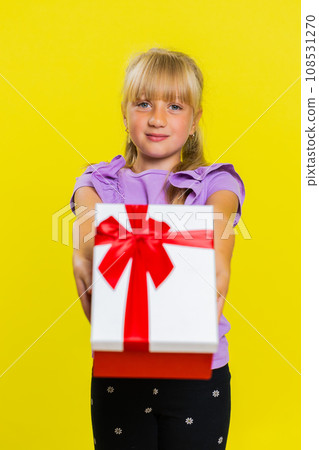 Lovely smiling preteen child girl kid presenting birthday gift box offer wrapped present celebrating Lovely smiling preteen child girl kid presenting birthday gift box offer wrapped present celebrating 108531270