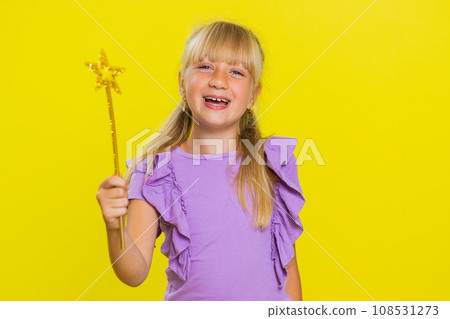 Child girl witch gesturing with magic wand fairy stick, making wish come true casting magician spell Child girl witch gesturing with magic wand fairy stick, making wish come true casting magician spell 108531273