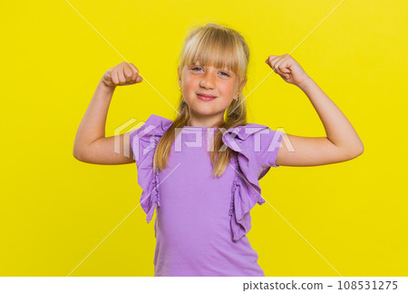 Fit sporty child girl kid showing biceps and looking healthy, feeling power strength success win 108531275