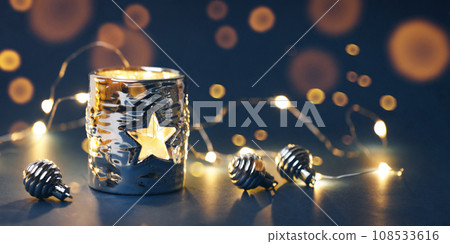 Christmas decorations with garland on dark background Christmas decorations with garland on dark background 108533616