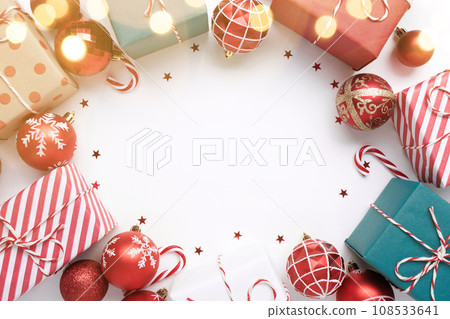 Christmas frame with gift boxes and balls on white 108533641
