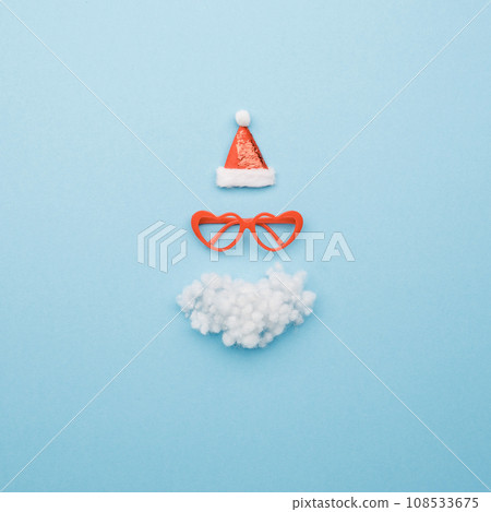 Santa hat, beard and glasses on color background top view 108533675