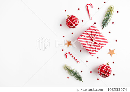 Christmas gift with decorations on white background Christmas gift with decorations on white background 108533974
