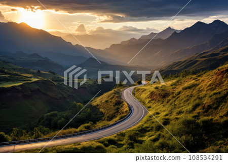 A  winding road going into the distance by the setting sun 108534291