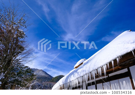 Blue sky and house buried in snow Blue sky and house buried in snow 108534316