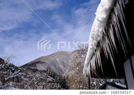 thatched roof and icicles 108534317