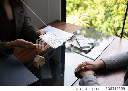 Real estate agent presenting and approved home loan contract. Real estate investment, Home mortgage concept. 108534869