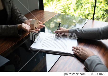 Real estate agent presenting and approved home loan contract. Real estate investment, Home mortgage concept. Real estate agent presenting and approved home loan contract. Real estate investment, Home mortgage concept. 108534872
