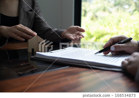 Real estate agent presenting and approved home loan contract. Real estate investment, Home mortgage concept. 108534873