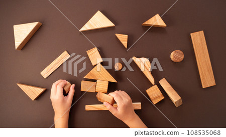 Child hands playing with wooden blocks Child hands playing with wooden blocks 108535068