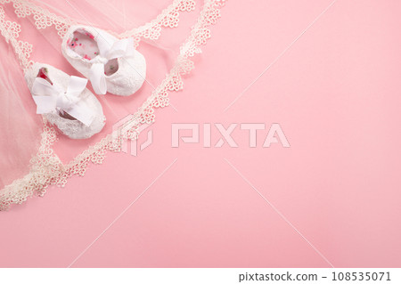 Christening background with baptism baby shoes on pink background Christening background with baptism baby shoes on pink background 108535071