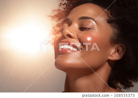 Close-up of young smiling African American woman with her eyes closed. Beautiful face of colored girl with perfect skin. Skin care, facial cosmetics. Monochrome background, copy space. Close-up of young smiling African American woman with her eyes closed. Beautiful face of colored girl with perfect skin. Skin care, facial cosmetics. Monochrome background, copy space. 108535373