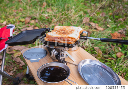 Hot sandwich eaten outdoors 108535455