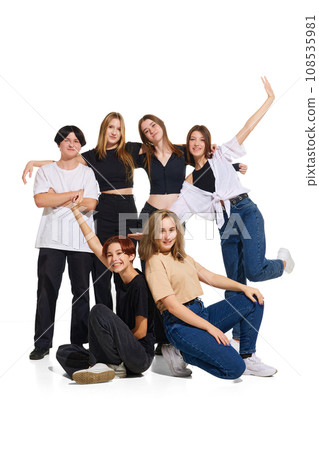 Full-length portrait of group of young beautiful stylishly dressed teenager girls against white studio background. Concept of youth fashion. 108535981