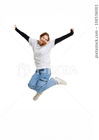 happy cheerful and cute young girl, jumping and raised hands of joy isolated white studio background. 108536003