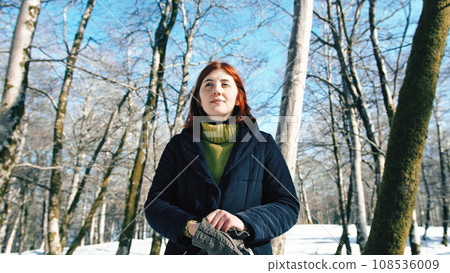 Young girl happy in the snowy forest during winter  108536009