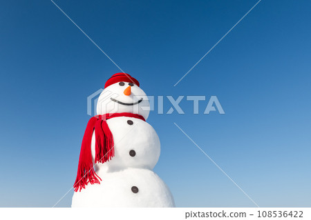 A jolly snowman wears a stylish red hat A jolly snowman wears a stylish red hat 108536422