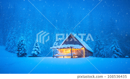 A wooden chalet standing alone in the midst of a snowy mountain A wooden chalet standing alone in the midst of a snowy mountain 108536435