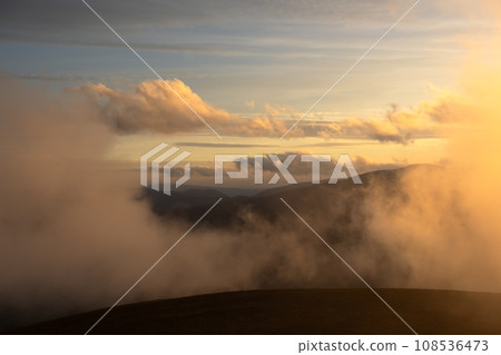 Sunset with fog in autumn mountains 108536473