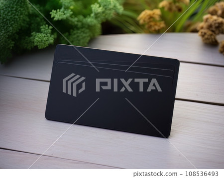 Black bank credit card on wooden table isolated AI 108536493